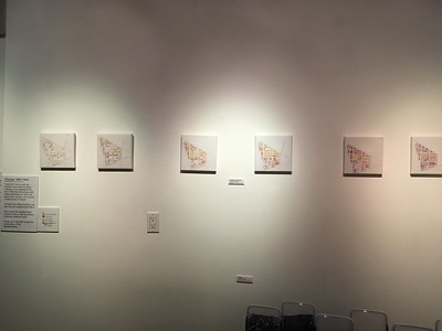Art exhibit wall showing 6 maps